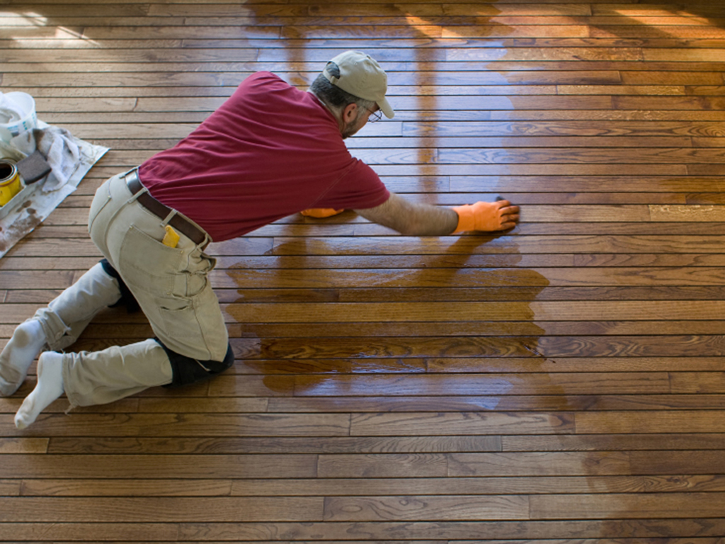 a fabulous floors technician refinishing a wood floor