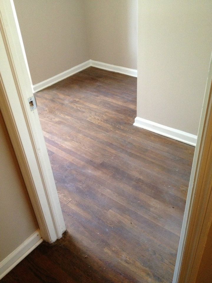 a wood floor before a Fabulous Floors refinishing